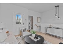 Bright living area with light wood floors and modern decor, including a view to the ensuite bathroom at 1007 Hundley Pl, Durham, NC 27701
