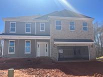 New two-story home featuring a brick and gray siding exterior, large windows, and an attached two-car garage at 124 Hemlock Falls Trl # 189, Raleigh, NC 27603