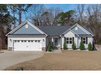 Charming one-story home with a well-manicured lawn and an attached two-car garage at 127 Landfall Ln, Smithfield, NC 27577