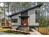 Modern two-story home with unique architectural design and landscaped front yard featuring a charming guest house at 1407 Carroll St, Durham, NC 27707