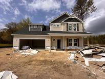 New two-story home featuring neutral siding, dormer windows, attached garage and landscaping potential at 20 Trescott St, Smithfield, NC 27577