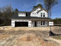 New construction home showcasing a two-story layout with a two-car garage and a covered front porch at 20 Trescott St, Smithfield, NC 27577