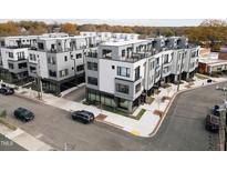 Modern townhome complex with rooftop terraces and contemporary design in a walkable urban neighborhood at 2002 Moody Ln, Durham, NC 27701