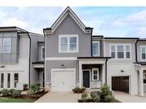Charming two-story home with a gray siding, a garage, and beautifully landscaped front yard at 2003 Regal Dr # 90, Durham, NC 27703