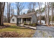 Charming single-story home with a cozy front porch and well-maintained landscaping at 2120 Canterbury Rd, Clayton, NC 27520