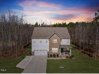 Beautiful two-story home featuring mixed siding, well-manicured lawn, and attached two-car garage at 2233 Kanata Mills Rd, Wake Forest, NC 27587