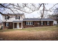 Two-story home with mixed brick and vinyl siding and manicured lawn at 2404 Pearces Rd, Zebulon, NC 27597