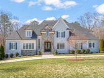 Beautiful two-story home with manicured lawn, stone accents, and a stately entrance at 40 Park Meadow Ln, Youngsville, NC 27596