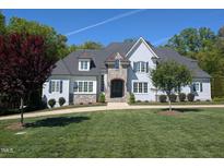 Stately home with lush lawn, stone accents, and charming architectural details at 40 Park Meadow Ln, Youngsville, NC 27596