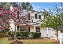 Charming two-story home featuring blooming magnolia tree and a well-manicured lawn at 406 Homestead Park Dr. Dr, Apex, NC 27502