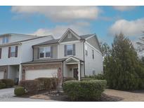 Inviting two-story home with a well-maintained yard and attached two-car garage at 420 Retreat Ln, Wake Forest, NC 27587