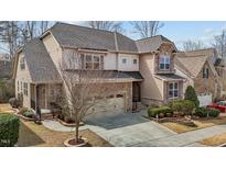 Charming two-story home featuring stone and siding, with a two-car garage and well-manicured landscaping at 5012 Trembath Ln, Cary, NC 27519
