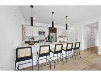 Modern kitchen features a large island with seating, stainless steel appliances, and stylish pendant lighting at 615 W Peace St # 301, Raleigh, NC 27605