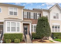 Charming townhome with brick accents, a well-manicured yard, and inviting front steps at 7810 Spungold St, Raleigh, NC 27617
