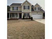 Charming two-story home featuring a classic design and a well-maintained lawn, complemented by black shutters at 82 Cool Creek Dr, Willow Springs, NC 27592