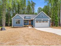 Beautiful single-story home featuring a two-car garage and a well-manicured front lawn at 9231 Bear Run Ln, Middlesex, NC 27557