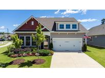 Charming home with a two-car garage and well-manicured lawn and colorful flowerbeds at 1 Parker Pond Ct, Durham, NC 27703