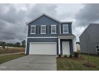 Charming two-story home with a white garage door, white trimmed windows, and a landscaped front yard at 103 Gabriel Ct, Clayton, NC 27520