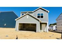 New construction featuring light green siding, an unfinished front yard, and an attached garage at 105 Gabriel Ct, Clayton, NC 27520