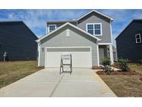 Charming gray two-story home with a two-car garage and a well-manicured lawn in a friendly neighborhood at 105 Gabriel Ct, Clayton, NC 27520