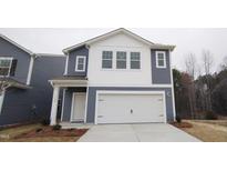 Charming two-story home featuring blue siding, white accents and a two-car garage at 1120 Solace Way, Rolesville, NC 27571