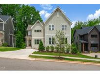 Beautiful two story home featuring neutral siding, charming landscaping, and concrete driveway at 12912 Grey Willow Dr, Raleigh, NC 27613
