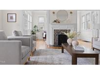 Bright living room with a fireplace and hardwood floors at 201 W Trinity Ave, Durham, NC 27701