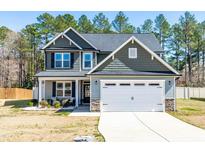 Charming two-story home with a well-manicured lawn and an attached two-car garage at 238 Ashpole Trail Trl, Clayton, NC 27520
