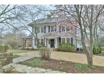 Charming two-story home with a landscaped front yard and flowering tree at 301 Hillsborough St, Chapel Hill, NC 27514