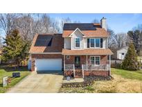 Charming two-story home with brick facade, front porch, solar panels and manicured landscaping at 304 Briarwood Dr, Mebane, NC 27302