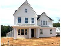 New two-story home showcasing a white exterior, a covered porch with columns, and multiple windows at 3200 Balcon Ct # 28, Angier, NC 27501