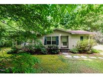 Charming single-story home featuring a well-manicured lawn and tasteful landscaping at 441 Wintergreen Rd, Timberlake, NC 27583