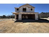 Exterior view of new construction featuring a covered garage, situated on a spacious lot, awaiting customization at 9 W Emily Gardens Dr, Selma, NC 27576