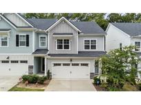 Charming two-story home featuring a two-car garage, well-maintained landscaping, and classic architectural details at 1634 Brussels Dr, Apex, NC 27502