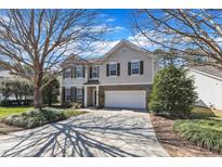 Two-story home showcasing a well-kept lawn, complementing the house's inviting facade and attached two-car garage at 2224 Cedar Grove Dr, Durham, NC 27703