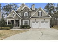 Charming two-story home with a stone facade and a two-car garage at 2401 Chianti Ct, Apex, NC 27502