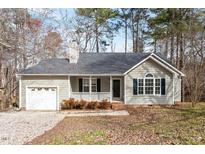 Charming single-story home with gray siding, a covered front porch, and an attached one-car garage at 262 Tillamook Dr, Wake Forest, NC 27587
