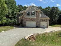 Beautiful two-story home featuring a stone facade and an attached two-car garage at 3005 Domaine Dr, Wake Forest, NC 27587
