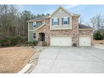 Beautiful two story home with stone and siding, three car garage, and extended driveway at 3005 Domaine Dr, Wake Forest, NC 27587
