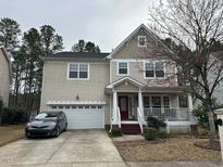 Charming two-story home with a welcoming front porch and attached two-car garage at 3032 Kilarney Ridge Loop, Cary, NC 27511