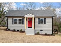 Charming renovated single-story home with a gray exterior, red front door, and simple landscaping at 312 W Union St, Hillsborough, NC 27278