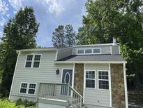 Charming two-story home with light gray siding and a stone accent wall at 4807 Tyne Drive, Durham, NC 27703