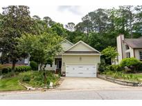 Charming single-Gathering home with attached two-car garage, lush landscaping, and inviting curb appeal at 4909 Willow Tree Ln, Clayton, NC 27520