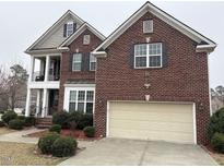 Charming brick home with a two-car garage and a covered front porch at 501 Liberty Rose Dr, Morrisville, NC 27560