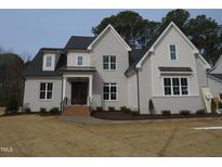 Charming two-story home featuring a gray painted brick exterior and a beautifully landscaped front yard at 505 Ansley Ridge Rdg, Cary, NC 27518