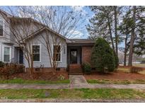 Charming townhome with a brick foundation, tidy landscaping, and a welcoming entrance at 1000 Hempstede Dr, Zebulon, NC 27597