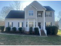Charming two-story home with a well-maintained lawn and manicured shrubs enhancing its curb appeal at 101 Feezor Ct, Clayton, NC 27527