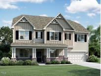 Charming two-story home featuring a welcoming front porch, black shutters, and a well-manicured lawn at 1427 Sparkling Lake Dr # 62, Apex, NC 27523