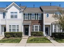 Charming townhome featuring a well-manicured lawn and traditional architectural details at 205 Cedar Elm Rd, Durham, NC 27713