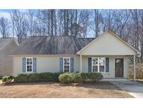 Charming single-story home features a cozy front porch and blue shutters at 220 Courtland Dr, Angier, NC 27501